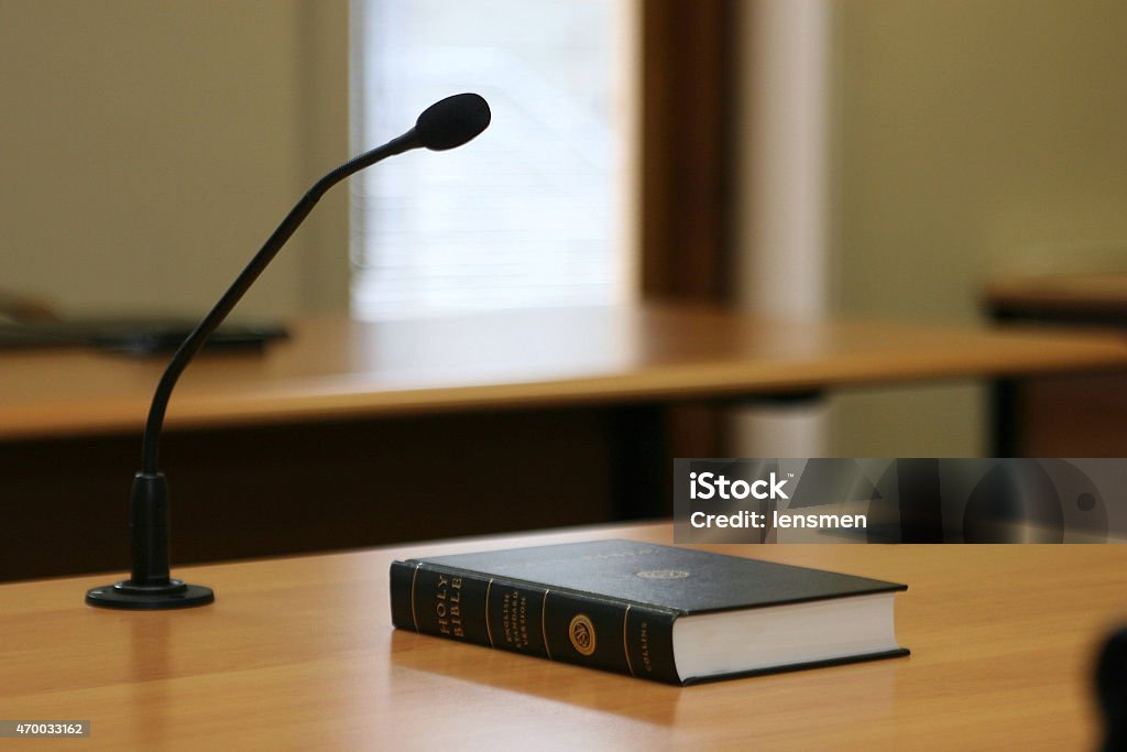 Courtroom microphone and book on table