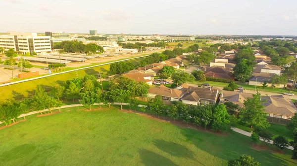 Top view green large urban park near residential area