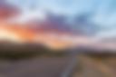 Road through dramatic sunset and sky over desert landscape